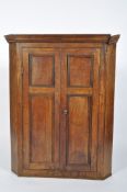 A French 19th century corner cupboard, with two reeded double doors enclosing three shelves,