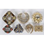 A collection of twenty costume brooches of variable designs, gross weight 257 grams.