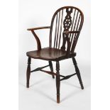 A wheel back ash and elm Windsor chair, 19th century, with carved wheel and scroll splat,