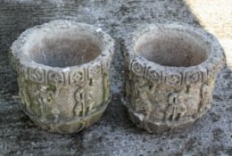 Two reconstituted stone octagonal planters, cast with figural and flowerhead decoration,