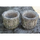 Two reconstituted stone octagonal planters, cast with figural and flowerhead decoration,