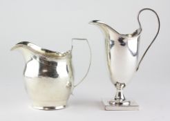 A silver cream jug, of slightly swollen form with chased decoration and a crest beneath the spout,