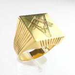 A large yellow metal square head signet ring with masonic engraving.