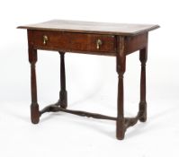 An 18th century oak low boy, with a single drawer, turned legs and H stretcher,