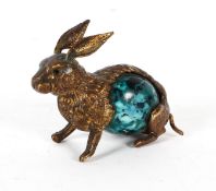 A novelty gilt metal tape meaure holder in the form of a rabbit, the tail acting as a winder,