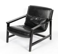 A late 20th century lounge chair with ebonised frame and upholstered seat in a faux leather fabric,