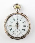An open face pocket watch. White circular dial with roman numerals and floral design.