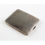 A silver cigarette case of rectangular form, engine turned decoration throughout,