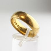 A yellow metal 6.20mm D shape wedding ring with personal inscription.