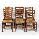 A group of six oak and rush ladder back chairs in varying designs,