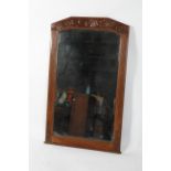 An Art Nouveau oak wall mirror, circa 1900, the bevelled,