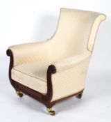 A Regency style armchair, with a scrolled back and arms on a carved frame, with cream upholstery,