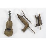 Three novelty brass locks, in the form of a cello, crayfish and monkey,