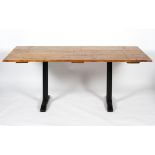 A kitchen table made from an oak door on metal legs,