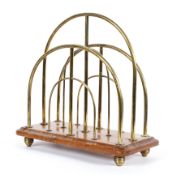 A vintage, mid 20th century brass and wooden-mounted magazine rack, stamped WR & S below a sunburst,