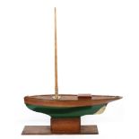 A large Victorian wooden and brass-mounted model of a boat, on oak stand, the hull painted in green,