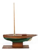 A large Victorian wooden and brass-mounted model of a boat, on oak stand, the hull painted in green,