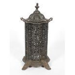 A Victorian cast iron stove and cover, late 19th century, of lobed cylindrical form,