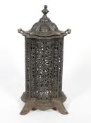A Victorian cast iron stove and cover, late 19th century, of lobed cylindrical form,