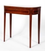 A George III mahogany folding card table of serpentine form,