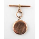 A rose metal circular locket pendant with attached heavy weight T bar. Hallmarked 9ct gold.
