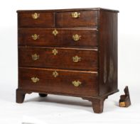 A Georgian oak chest of two short and three graduated long drawers,