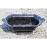 A cast iron planter, of oval form, with cast ribbon decoration,