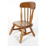 A child's elm kitchen chair, with spindle back, on splayed legs,