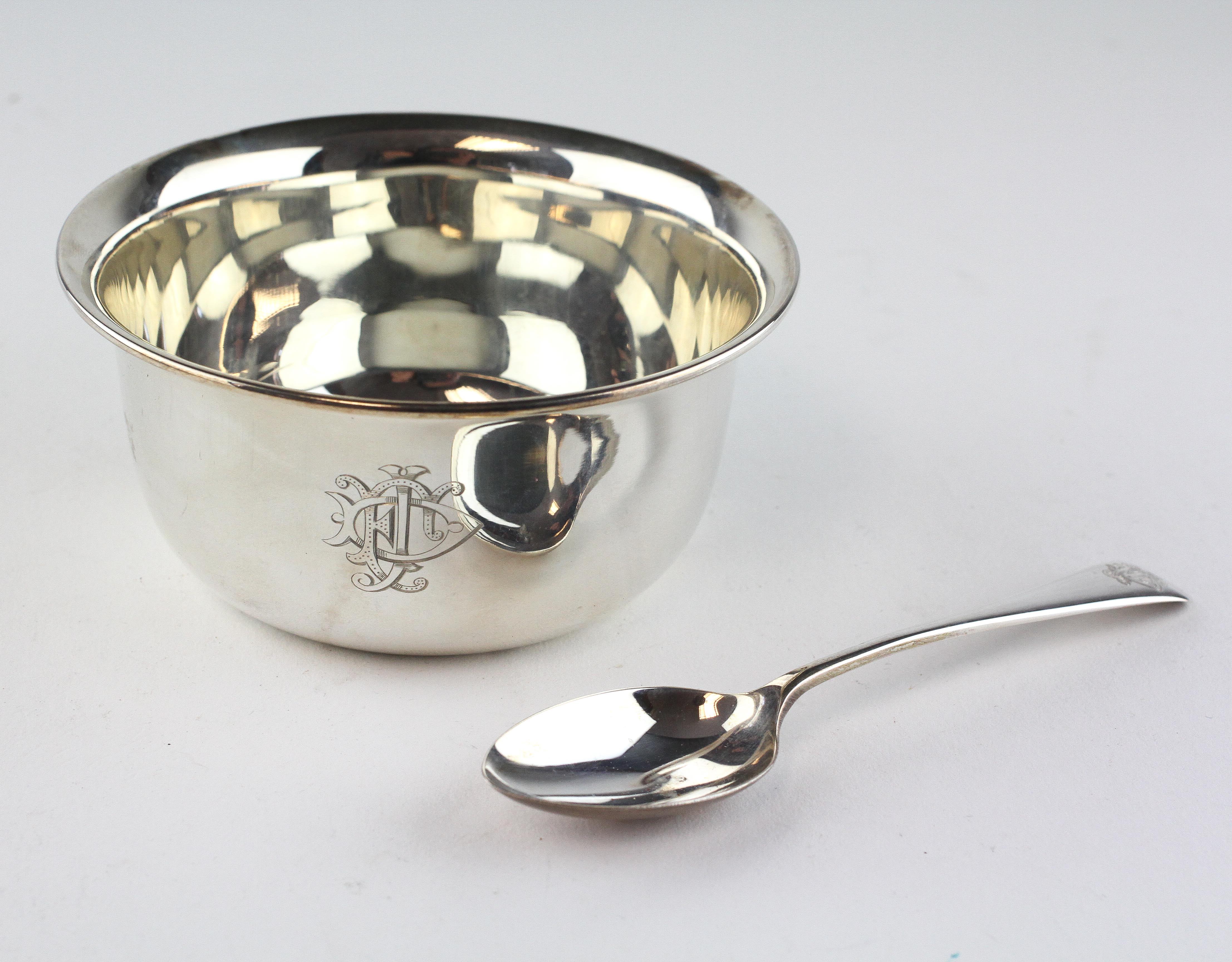 An early 20th century silver christening bowl with matching spoon,