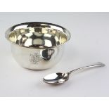 An early 20th century silver christening bowl with matching spoon,
