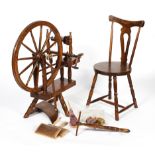An oak antique style spinning wheel and a spinning chair, by John Brightwell, of traditional form,