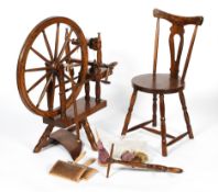 An oak antique style spinning wheel and a spinning chair, by John Brightwell, of traditional form,