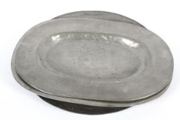 Two pewter oval platters and a charger, 18th/19th century, un-decorated,