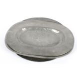 Two pewter oval platters and a charger, 18th/19th century, un-decorated,