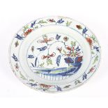 An English delftware polychrome charger, circa 1760, probably Bristol,(cracked and restored),