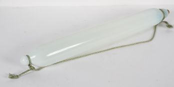 A large Nailsea-type milk glass rolling pin, late 19th century, with cork stopper,