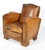 A vintage tan leather club chair in the Art Deco style, on block feet,