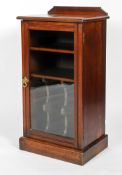 An Edwardian mahogany music cabinet, with raised back and glazed door,