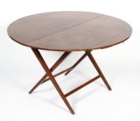 A Victorian mahogany coaching table, the circular top on a folding X frame, 60cm high,