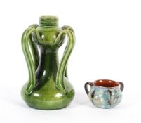 A Continental Arts and Crafts green glazed vase and a C.H. Brannam pottery three-handled salt,