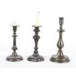 A pair of Dutch style pewter candlesticks, with a broad drip pan and domed foot,