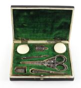 A Victorian papier mache sewing set case, containing a matched white metal sewing set,