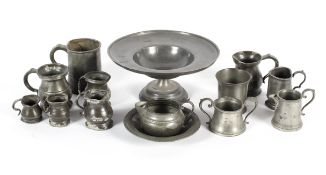 A collection of pewter tankards and measures of various shapes,