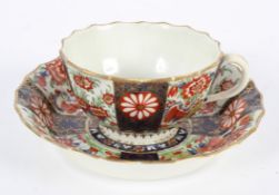 A Worcester Teacup and Saucer, of Warmstry Fluted form, in a Japan pattern, square seal marks,