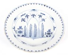 An English delftware blue and white charger, circa 1760, probably London or Bristol,