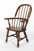 A child's elm Windsor chair, on turned baluster splayed legs,