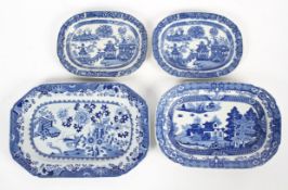 A pair of 19th century pearlware sauce tureen stands, blue printed with a 'Willow' style pattern,