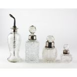 Two silver topped cut-glass sent bottles,