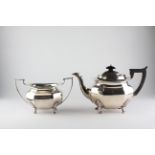 A George V silver teapot of octagonal form, raised upon four feet,