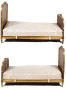 A pair of giltwood bergere bedsteads, the floral decoration to the centres, 130cm high x 111cm wide,